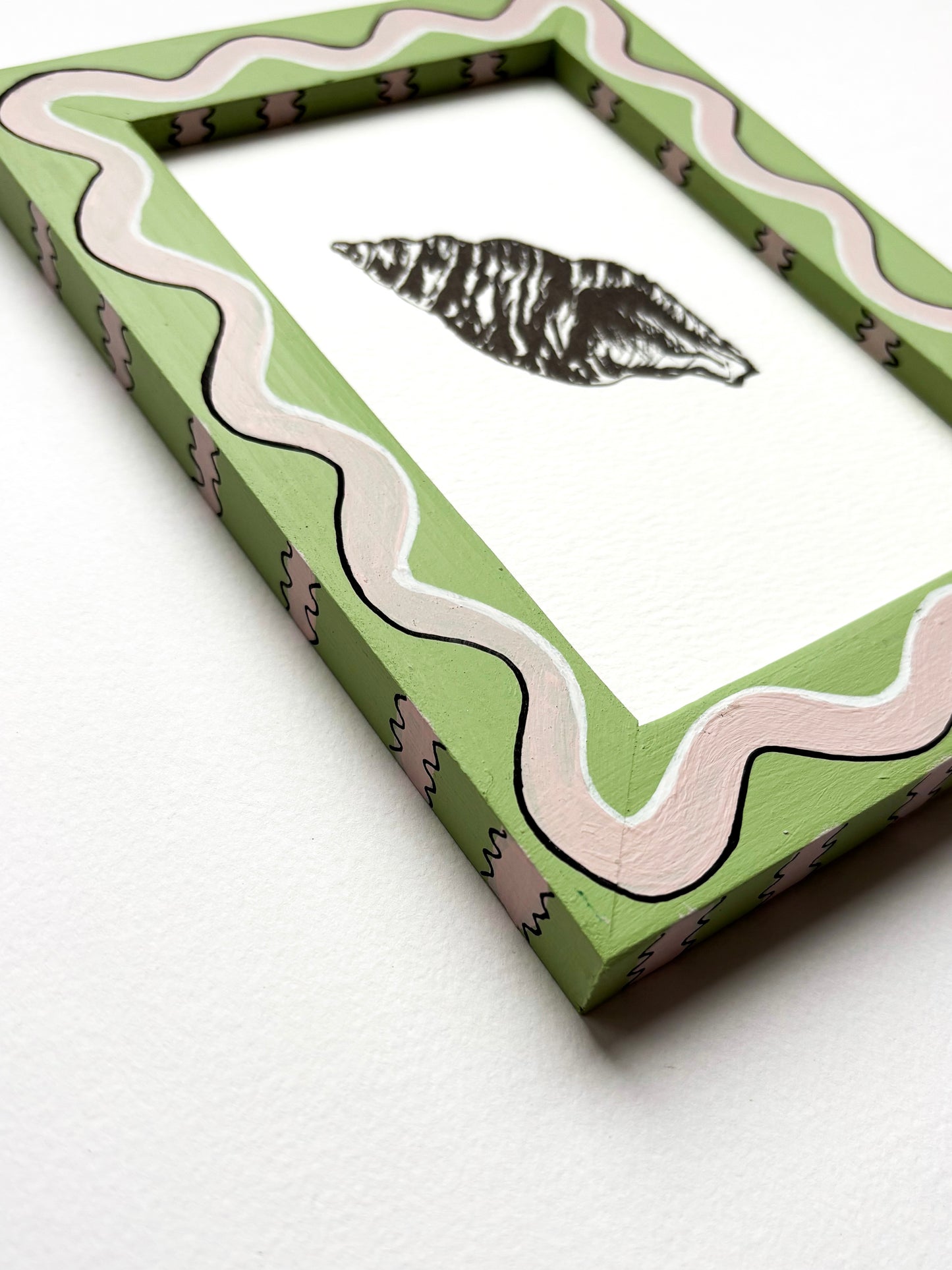 SHELL ORIGINAL INK ARTWORK IN A HAND PAINTED PALE GREEN AND PINK WIGGLE AND STRIPED PRELOVED FRAME
