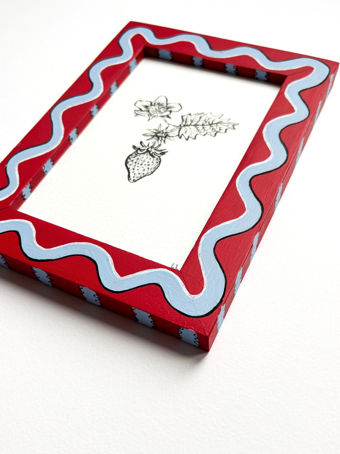 STRAWBERRY ORIGINAL INK ARTWORK IN A HAND PAINTED RED AND BLUE WIGGLE AND STRIPED PRELOVED FRAME