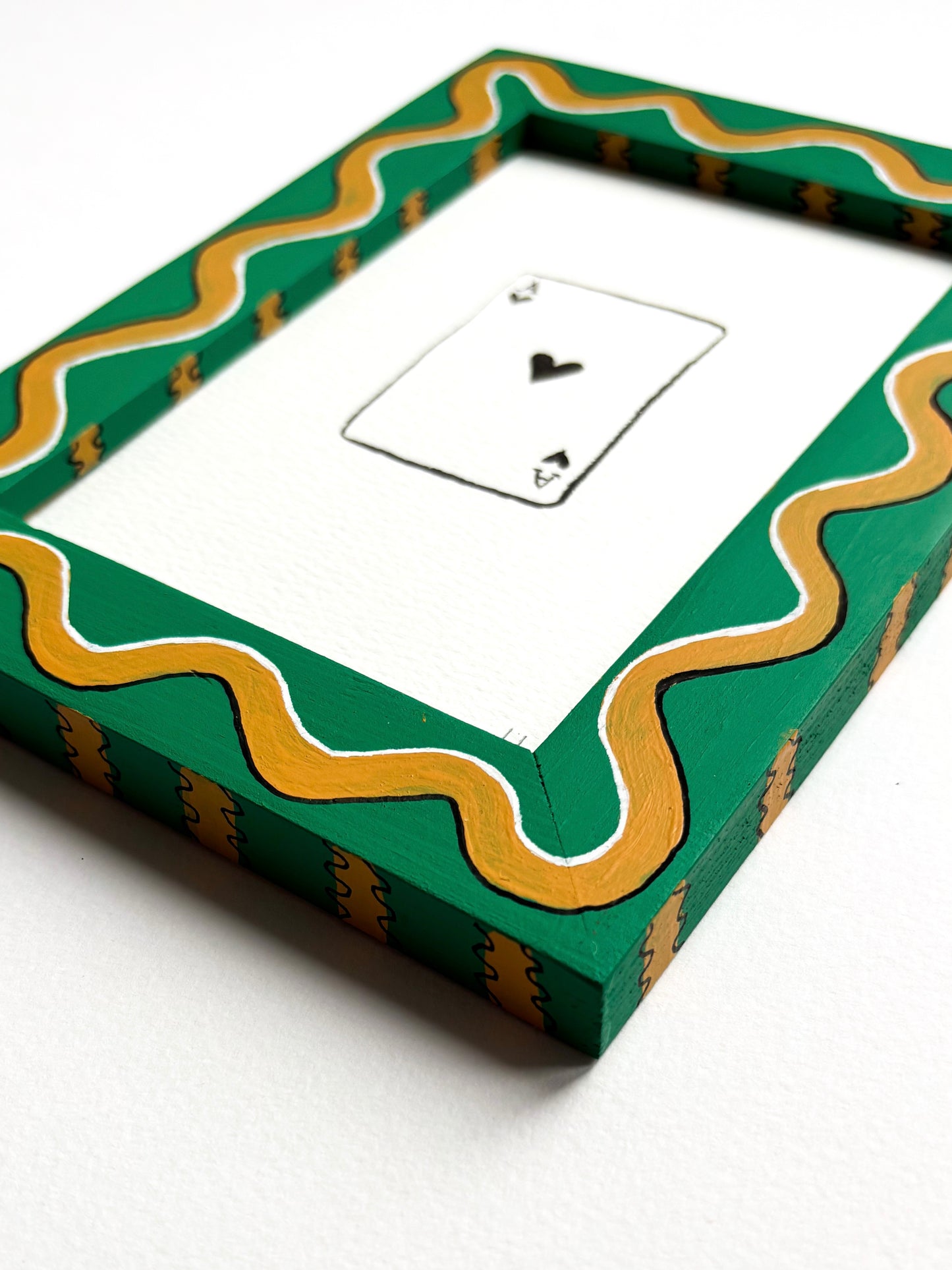 PLAYING CARD ORIGINAL INK ARTWORK IN A HAND PAINTED GREEN AND MUSTARD WIGGLE AND STRIPED PRELOVED FRAME