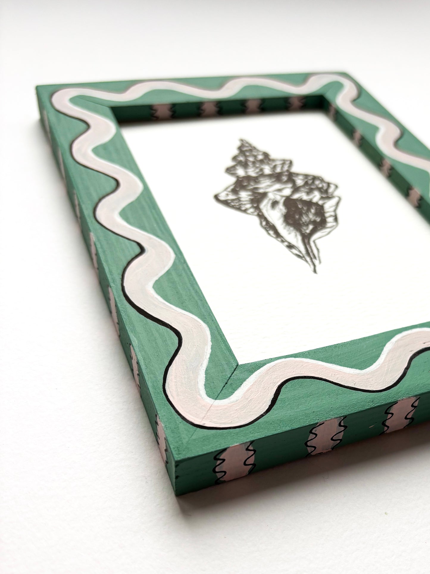 SHELL ORIGINAL INK ARTWORK IN A HAND PAINTED GREEN AND PALE PINK WIGGLE AND STRIPED PRELOVED FRAME
